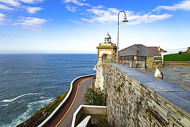 The majestic Atlantic Ocean. Asturias. Romantic trip to Spain. Beautiful road to lighthouse and Chapel de la Atalaya. Unusual impressive architecture of the Luarca