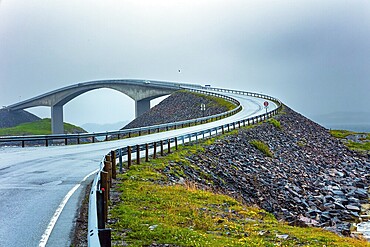 Scenic bridge over the ocean. Atlantic Road: the most beautiful road in the world. Cold and stormy July day. Rain over the famous bridge in the icy sea. Norway