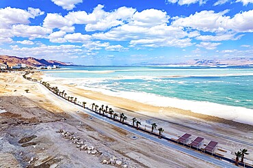 Israel. The Dead Sea is an endorheic salt lake. Magnificent resort for treatment and relaxation. Drone filming. The picturesque embankment is lined with palm trees