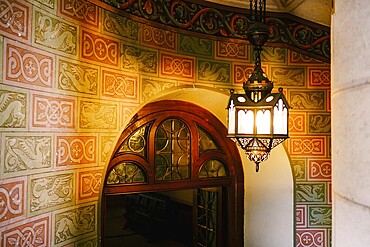 Antique wall lamp on a spiral staircase in Neuschwanstein Castle.