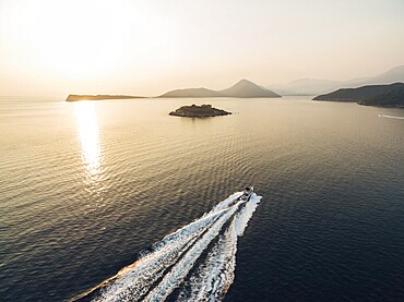 Motor boat sails to the Mamula fortress on the island. Kotor Bay.