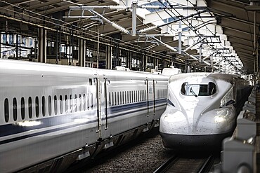 KYOTO, JAPAN - SEPTEMBER 24 2024: A Shinkansen high-speed bullet train arriving at Kyoto Station in Kyoto, Japan, Asia