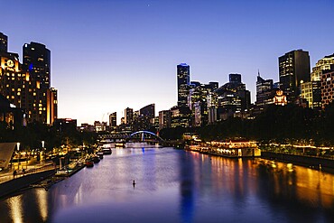 MELBOURNE, AUSTRALIA - OCTOBER 10, 2024: Melbourne skyline from Princes Bridge in Southbank along the Yarra River at dusk in Victoria, Australia, Oceania