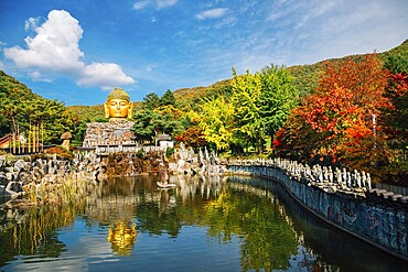 Golden buddha statue and pond in Wawoo Temple, Korea