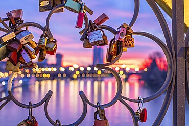 Sunrise on a riverbank in the centre of a big city. Spring with a view of the skyline of the banking district and the historic buildings of Frankfurt, Hesse