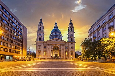 Old church, cathedral in a historic city centre in Eastern Europe. Sunrise on a city square in front of St Stephen's Basilica in Budapest, Hungary, Europe