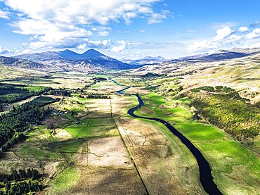 Farms and Mountains over River Dochart and Road A85 from a drone, Perthshire, Scotland, UK