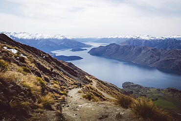 Spectacular views from a path leading through a mountainous landscape to a lake, Roys Peak, Wanaka, New Zealand, Oceania