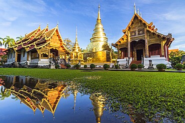 Wat Phra Singh temple, blue sky and reflection in water. Chiang Mai, Thailand, Asia