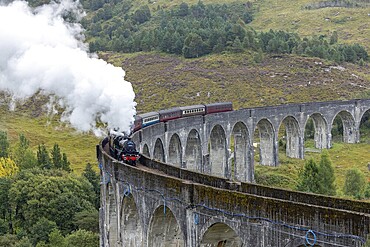 The Jacobite Steam Train, steam railway on the Glenfinnan railway viaduct, known from Harry Potter, Glenfinnan, Highlands, Scotland, Great Britain