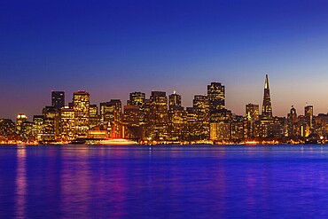 San Francisco sunset skyline in California with reflection in bay water USA