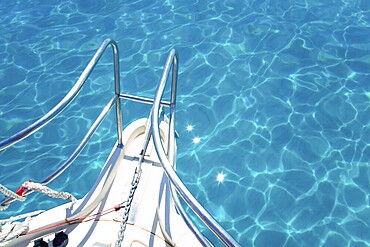 Balearic blue clean turquoise water from boat bow high angle view