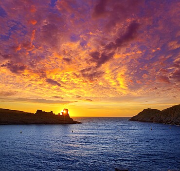 Menorca sunset in Cala Morell at Ses torretes beach Balearic Islands