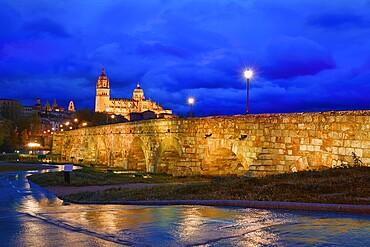 Salamanca skyline sunset and roman bridge over Tormes river in Spain