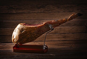 Iberian ham pata negra from Spain on wood background