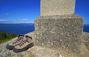 Used boots shoes at the end of Saint James Way in Finisterre Fisterra Camino de Santiago Spain