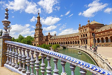 Plaza de España in Seville with magnificent architecture and bridge on a sunny day with clouds, Seville, Spain, Europe