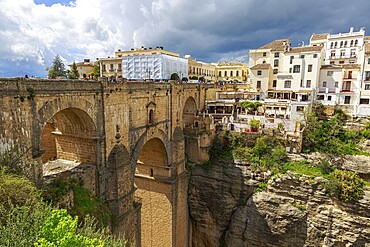 The imposing Puente Nuevo bridge in Ronda, which crosses a deep ravine, surrounded by historic buildings, Ronda, Spain, Europe
