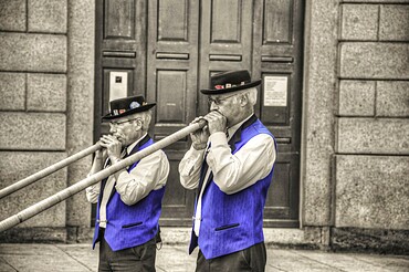 Two Men with Playing Music with Alp Horn in Lugano, Ticino, Switzerland, Europe
