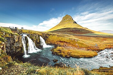 Landscape view of Kirkjufellsfoss In the daytime, blue sky and beautiful clouds. The waterfall is famous and a popular tourist spot in Iceland.