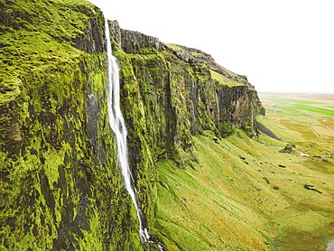Iceland waterfall nature travel landscape in Icelandic nature background. Popular tourist attraction summer holiday destination in on South Iceland.