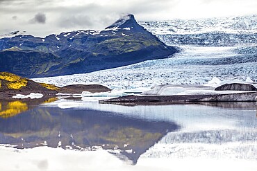 Glacier meltwater form a picturesque lake. The sunset over the Iceland's largest glacier Vatnajokull. The concept of extreme northern tourism