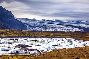 Sunrise in the Ice Lagoon. Drift ice Ice Lagoon - Jokulsarlon. Ice floes are reflected in the smooth water surface. The concept of extreme northern tourism