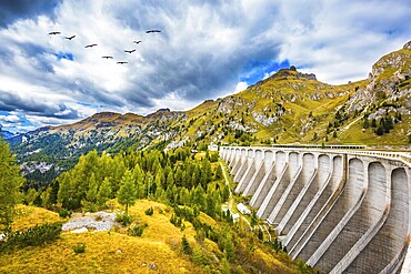 Powerful dam blocked the lake. Mountain Lake Lago di Fedaia, Dolomites. The concept of ecological and extreme tourism
