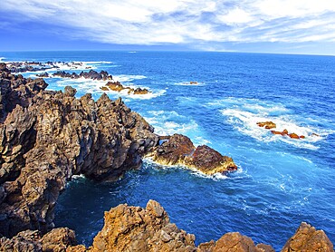 Rocks and grottoes of the Atlantic coast. Volcanic island of Madeira. Fantastically beautiful coast. The concept of exotic and ecological tourism