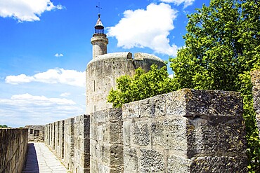 Antique walls of the medieval port city of Aigues-Mortes. The historic tower of Constance. Mediterranean coast of France. The concept of active, historical and photo tourism