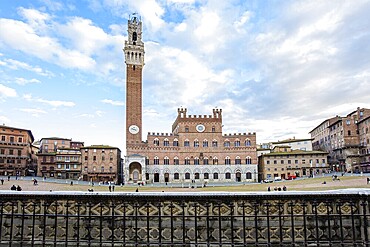 Winter trip to Tuscany. The old city centre of Siena. The famous expansive Piazza del Campo is a shell-shaped square. Torre del Mangia - the tallest tower in Siena