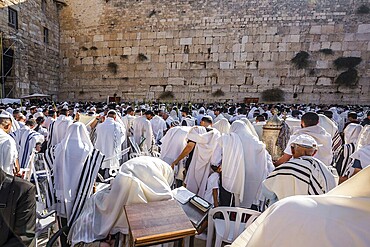 Blessing of the Cohenim in Passover. Jerusalem, Israel. Jews praying at the Western Wall wrapped in white Talit. Solemn celebratory ceremony at the Western slope of the Temple Mount. The concept of pilgrimage