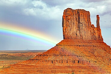 The famous rock Mittens and the bright rainbow. USA. Navajo Indian Reservations. Monument Valley is a unique geological formation in Arizona and Utah