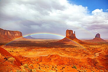 The bright rainbow all over the sky. Monument Valley is a unique geological formation in Arizona and Utah. The famous rock Mitten. USA. Navajo Indian Reservations