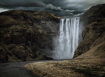 Majestic and dark Skogafoss waterfall in Iceland in a stormy day, moody atmosphere