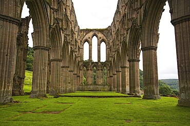 Scenic view of ruins of Rievaulx Abbey under cloudscape, North Yorkshire Moors, National Park, England, United Kingdom