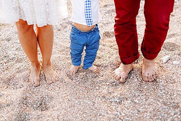 Family legs on the beach. Parents with children on the beach. Family holidays in Montenegro