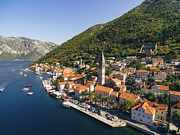 Drone view of the Perast coast with ancient houses and a tower. Montenegro.