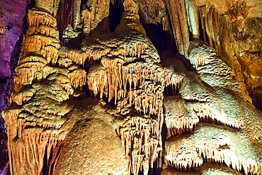 Venetsa Cave in Bulgaria. Beautiful colorful and illuminated cave full with semiprecious onyx stones. Flowstones, stalactites and stalagmites lighted in different vivid colours