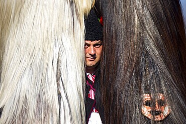 Pernik, Bulgaria - 28 January 2018: Participants take part in the International Festival of Masquerade Games Surva. The festival promotes variations of ancient Bulgarian and foreign customs and masks. Kukeri