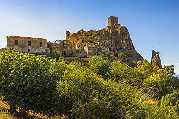 A picturesque view of the abandoned, old mountain town of Craco, built of sandstone rock. Craco is a ghost town abandoned due to an earthquake in the late 20th century. Province of Matera, Basilicata, Italy