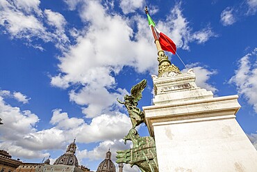 Close up of column of the famous National Monument the Vittoriano or Altare della Patria in Piazza Venezia with italian flag. Rome, Lazio, Italy