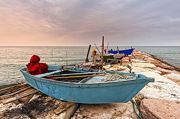 Fishing boat moored on cliff at sunset. Venice, Italy