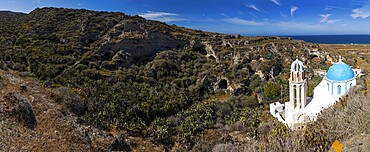 Monastery church of Panagia Agrilia, abandoned cave dwellings in erosion valley, panoramic view, island of Thirassia, archipelago of Santorini, Cyclades, Greece