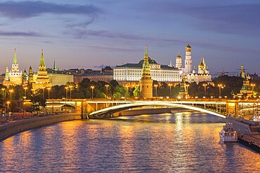 Illuminated Moscow Kremlin and Moscow River with bridge at night. Russia