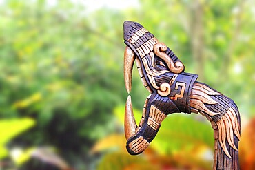 Chichen Itza Snake symbol wood handcraft figure in jungle Mexico Yucatan