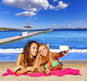 Happy girl friends selfie portrait beach sand in Mallorca photo mount