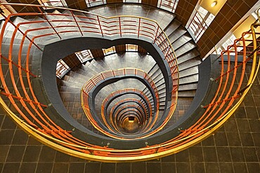Detailed spiral staircase with orange-coloured banister and tiled floor, fascinating and artistic, Kontorhausviertel, Old Town Hamburg, Free and Hanseatic City of Hamburg, Germany
