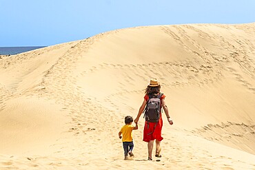 Mother and child on vacation in the dunes of Maspalomas, Gran Canaria, Canary Islands