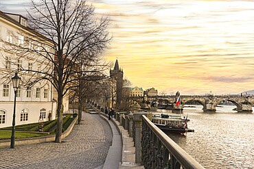 Scenic view of Charles Bridge and Moldava river at sunset in Prague, Czech Republic